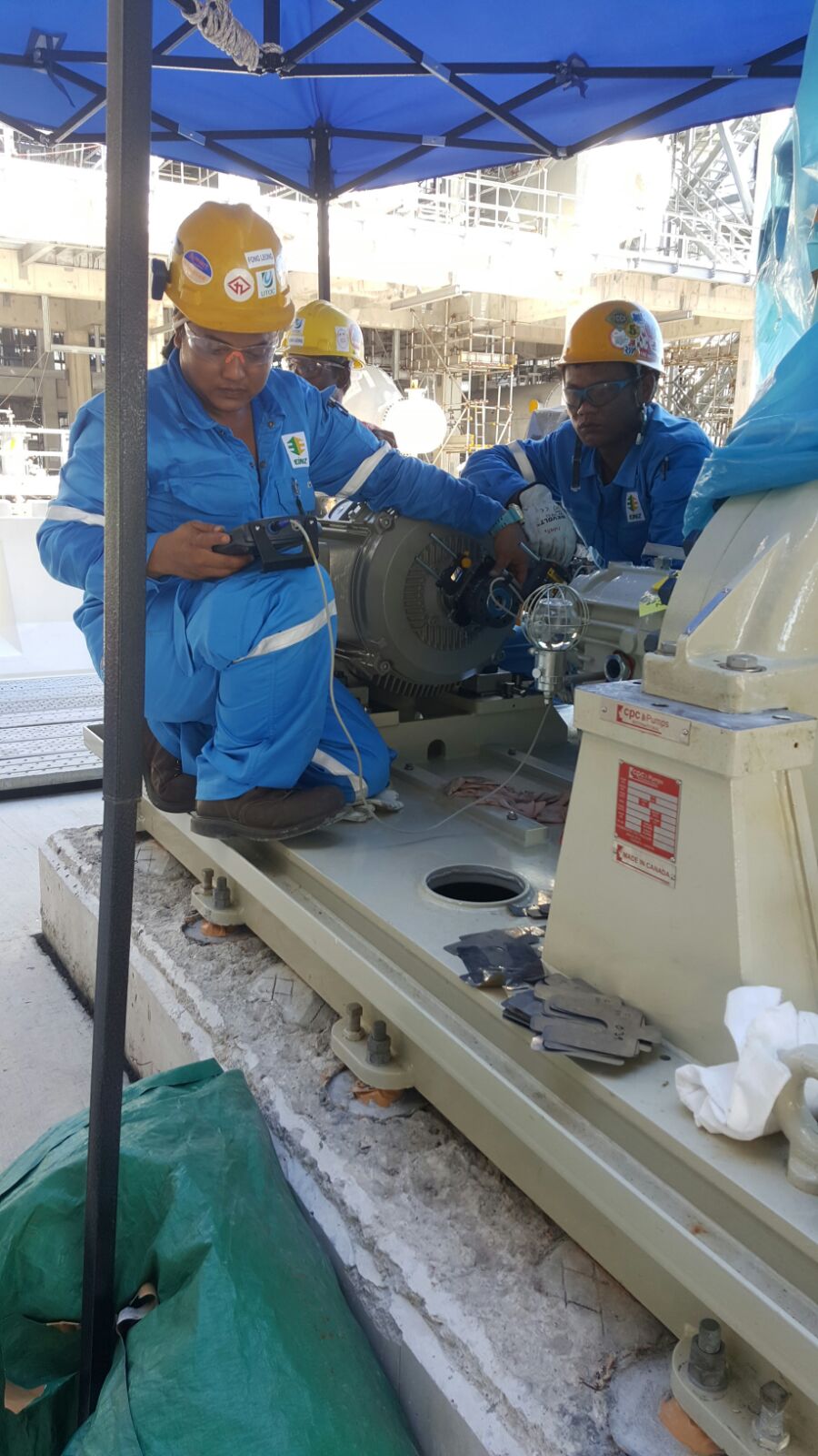 Millwright team conducting alignment and shimming on a baseplate