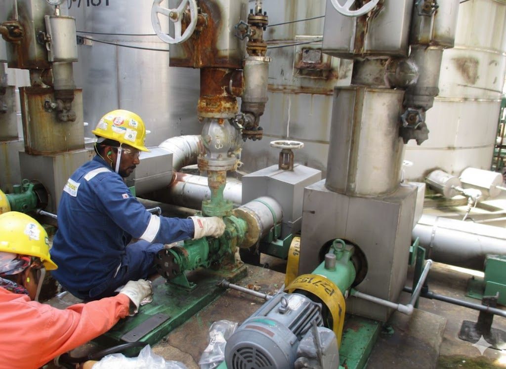 Millwrights performing precision alignment on a re-installed process pump